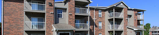 Apartments in central Lincoln Nebraska with beautiful landscaping, scenic views, large balconies, spacious balconies, huge swimming pool, and pool-side lounge chairs at Tanglewood Apartments