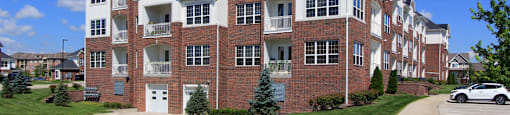 Luxury apartments in a gated community with brick exteriors and underground parking garage at Bellemeade Apartments in west Des Moines