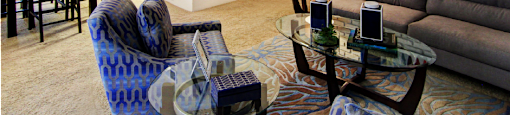 Spacious living room and dining room with white brick feature wall at Plantation apartments near the Galleria in Houston.