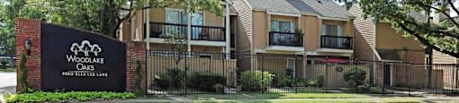 Gated apartments with convenient bayou location, scenic views, attached garages and covered parking at Woodlake Oaks Apartments in Houston