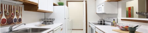 Bright white kitchen with lots of cabinet space, lots of counter space, and full-size washer and dryer in unit at LionsGate Apartments in Lincoln, Nebraska
