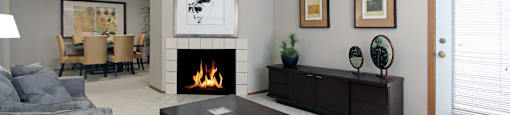 Spacious floor plan, open floor plan, spacious apartment with woodburning fireplace, spacious dining room, and gray wall color at The Vanderbilt Apartments in Omaha, Nebraska