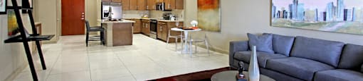 Luxury apartments with spacious open floor plan, granite countertops, stainless steel appliances, built-in wine rack, kitchen island, and porcelain tile floor at Bellemeade Apartments in west Des Moines