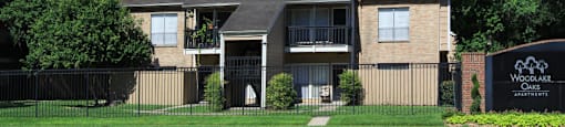 Gated apartments with convenient bayou location, scenic views, attached garages and covered parking at Woodlake Oaks Apartments in Houston
