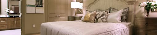 Master bedroom to accommodate a king-size bed and dresser with walk-in closet and master bathroom at Tuscany Apartments in Houston