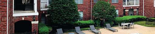 Luxury swimming pool with large sundeck at Tuscany Gate Apartments in Houston.
