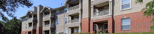 an exterior view of an apartment building on a sunny day
