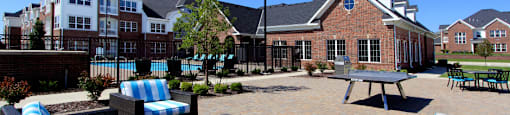 Luxury apartments with swimming pool, poolside lounges, grilling station, ping-pong table and brick exteriors at Bellemeade Apartments in west Des Moines
