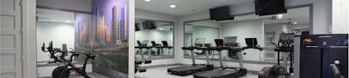 Newly remodeled Fitness Center open 24/7 with brand new Life Fitness equipment including 1 peloton bike, 4 resistance machines, 2 treadmills, 1 life cycle, 1 elliptical, full rack of free weights and dumbbells and water bottle refill fountain at Tuscany Apartments in Houston.