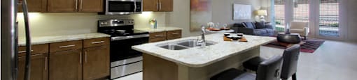 Luxury apartments with spacious open floor plan, granite countertops, stainless steel appliances, porcelain tile floors, and oversized windows at Bellemeade Apartments in west Des Moines