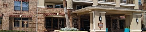 Luxury apartments with brick exteriors, two swimming pools, parking garage, and fitness center at The Voss Apartments in Houston.