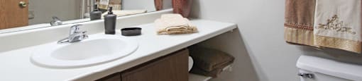 Bathroom with extra cabinet space and gray wall color, at the Vanderbilt Apartments in central Omaha, Nebraska