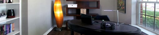 Luxury apartments with den, office space, wet bar, built-in shelves, oversized windows, and wood grain plank floors at Lenox Village Apartments in Lincoln, Nebraska