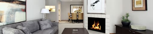 Spacious floor plan, gray wall color, spacious apartment with woodburning fireplace, spacious kitchen, spacious dining room, and bright white kitchen at The Vanderbilt Apartments in central Omaha, Nebraska