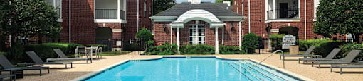 Luxury swimming pool with large sundeck at Tuscany Gate Apartments in Houston.