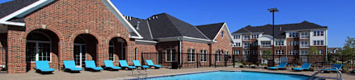 Luxury apartments with swimming pool, poolside lounges, and brick exteriors at Bellemeade Apartments in west Des Moines