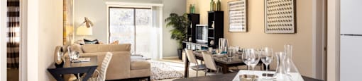 Apartments in central Omaha with open floor plan, open layout, condo-style layout, spacious living room, kitchen island, prep island, and colored feature wall at Embassy Park Apartments in Omaha, Nebraska