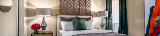 Spacious bedroom with walk-in closet and cozy grey wall color at Woodlake Oaks Apartments in Houston.