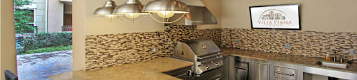 Luxury apartments with outdoor grilling station, granite bar top, and granite countertop at Villa Piana Apartments in Dallas