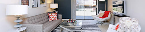 Spacious living room with colored feature wall at Embassy Park Apartments in Omaha, Nebraska