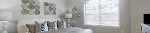 Huge master bedroom, spacious master bedroom with ceiling fan, high vaulted ceiling, over-sized windows, walk-in closet and attached luxury bath suite at Tuscany Villas in Houston.