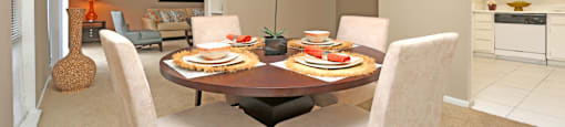 Spacious floor plan, spacious dining room with oversized windows, lots of natural light, bright white kitchen and built-in shelves at Woodlake on the Bayou Apartments in Houston.