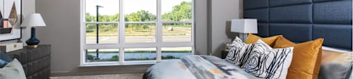 Luxury apartments with master bedroom to fit a king size bed, attached master bathroom and walk-in closet at Xenia Apartments in Golden Valley, Minnesota