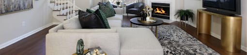 Spacious living room with wood-burning fireplace, wood plank flooring, huge living room at Tuscany Villas Townhomes in Houston.