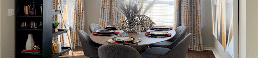 Luxury apartments with spacious dining room, oversized windows, and plank wood floors at Saddlebrook apartments in Urbandale Iowa