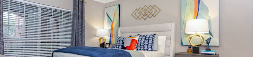 Spacious bedroom with gray colored walls, large windows and walk-in closet, at The Dorchester Apartments in Dallas Texas
