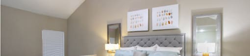 Huge master bedroom with vaulted ceiling and loft style layout with attached master bathroom and walk-in closet at Woodlake on the Bayou Apartments in Houston.