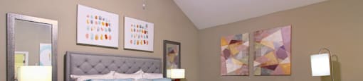 Huge master bedroom with vaulted ceiling and loft style layout with attached master bathroom and walk-in closet at Woodlake on the Bayou Apartments in Houston.