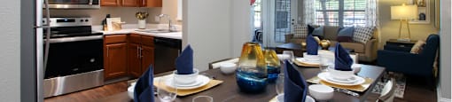 Luxury apartments with wood grain plank floors, dining room, u-shaped kitchen, 9-foot ceilings, gray colored walls, and built-in shelves, at Lenox Village Apartments in Lincoln, Nebraska