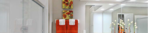Luxury apartments with oval soaking tub, built-in vanity, and glass shower at Lenox Village Apartments in Lincoln, Nebraska