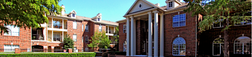 Gated apartment community near the Galleria in Dallas with luxury clubhouse and resident lounge, free wi-fi, meeting room, red brick exteriors, and beautiful landscaping at The Dorchester Apartments