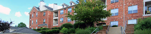Luxury apartments with red brick exteriors, garages, and lush landscaping at TurtleCreek apartments in West Des Moines, Iowa