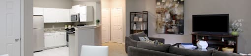 Apartments in southwest Omaha with spacious layout, spacious living room, spacious dining room, granite countertops, white kitchen cabinets, and stainless-steel appliances at Breckenridge Apartments in southwest Omaha, Nebraska