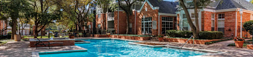 Luxury apartments with two resort-style swimming pools near the Mary Kay Museum with attached garages, golf course views, and beautiful landscaping in Dallas.