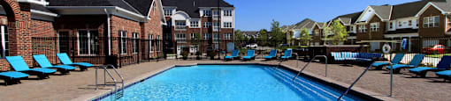 Luxury apartments with swimming pool, poolside lounges, grilling station, ping-pong table and brick exteriors at Bellemeade Apartments in west Des Moines