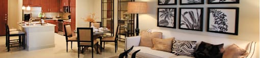 Luxury apartments next to the Galleria in Dallas with spacious floor plan, granite countertops, stainless steel appliances, built-in wine rack, kitchen island, and porcelain tile floor at Villa Piana Apartments in Dallas