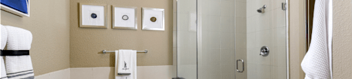 Luxury bathroom with granite countertops, glass shower and separate soaking tub at Luxembourg Apartments in Bloomington Minnesota