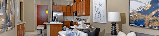 Luxury apartments in Bloomington Minnesota with spacious floor plan, granite countertops, stainless steel appliances, built-in wine rack, kitchen island, and porcelain tile floor at Luxembourg Apartments