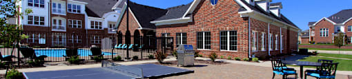 Luxury apartments with swimming pool, poolside lounges, grilling station, ping-pong table and brick exteriors at Bellemeade Apartments in west Des Moines