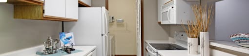Kitchen with lots of cabinet space, lots of counter space, gray wall color, and full-size washer and dryer at The Vanderbilt Apartments in Omaha, Nebraska