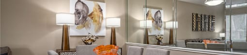 Dining area with mirror accent wall at Woodlake on the Bayou Apartments in Houston Texas
