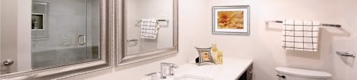 a bathroom with a sink toilet and a mirror