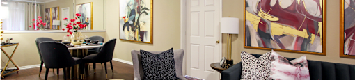 Luxury apartments with spacious dining room, wood plank floors, breakfast bar, mirror accent wall, and 9-foot ceilings at Kensington Square Apartments.