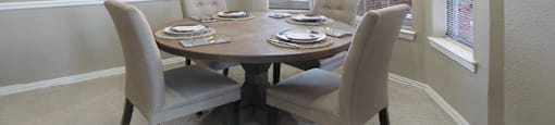 Luxury apartments in central Omaha with spacious dining room with bay windows, oversized windows, and crown molding at The Biltmore Apartments in Omaha, Nebraska