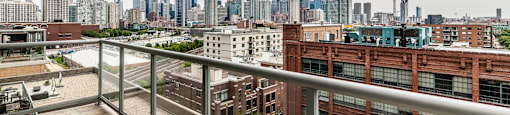 the view of the skyline from the balcony of a condo