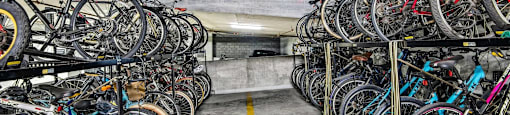 a bunch of bikes parked in a parking garage